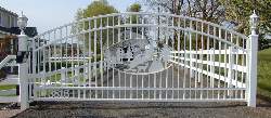 White powder coated iron entry gate with matching 3 rail fence
